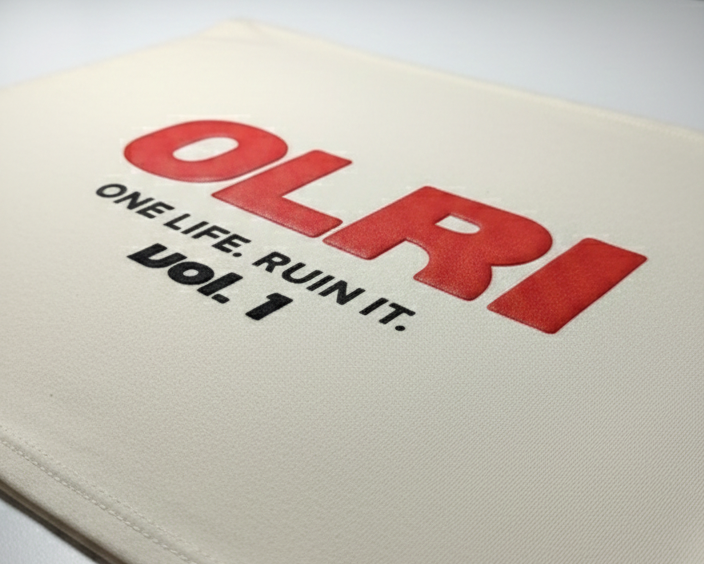 Beige fabric with red and black text on a white surface